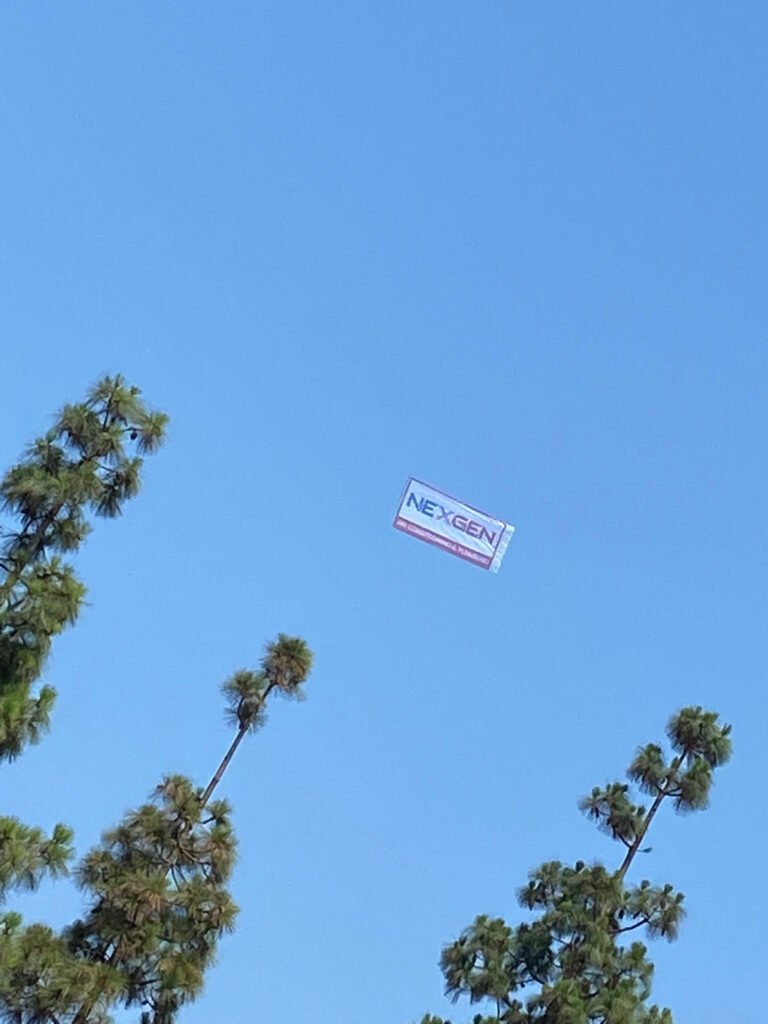 nexgen banner flying over our headquarters in a blue sky